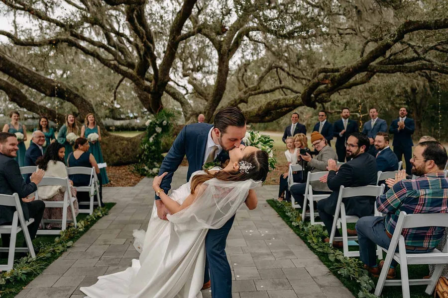 Matt dipping Marilia for a kiss in the aisle