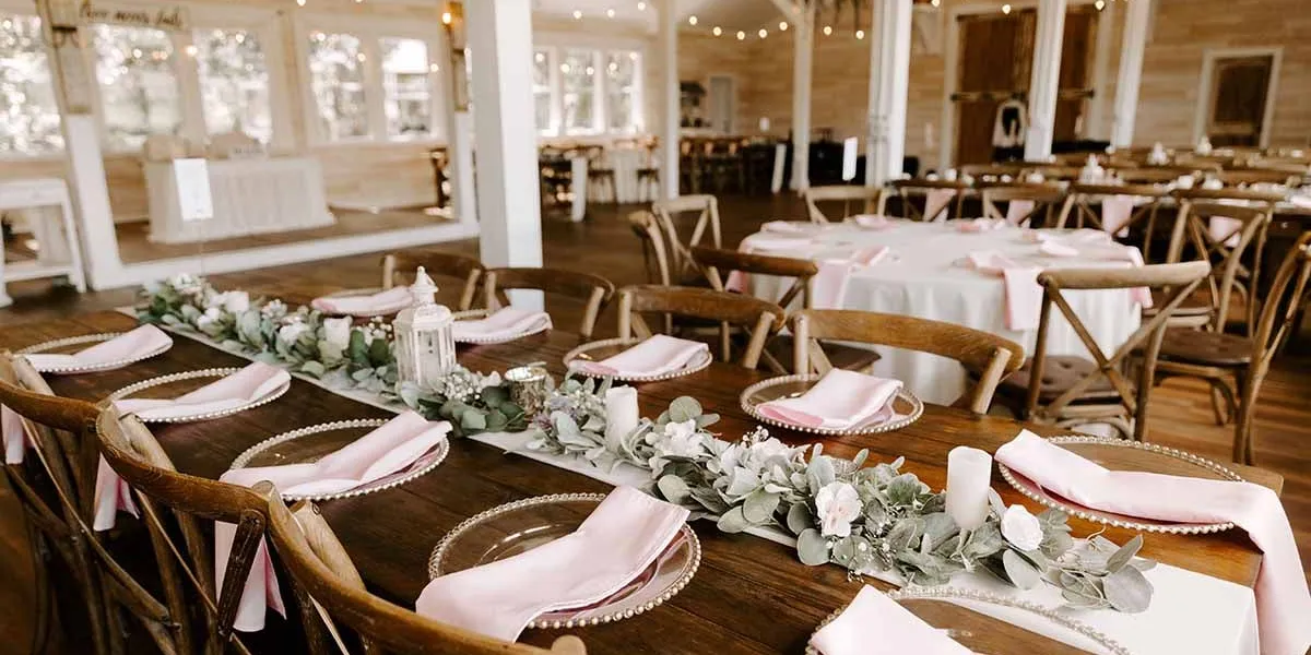 Tables set for a reception in the Legacy Barn
