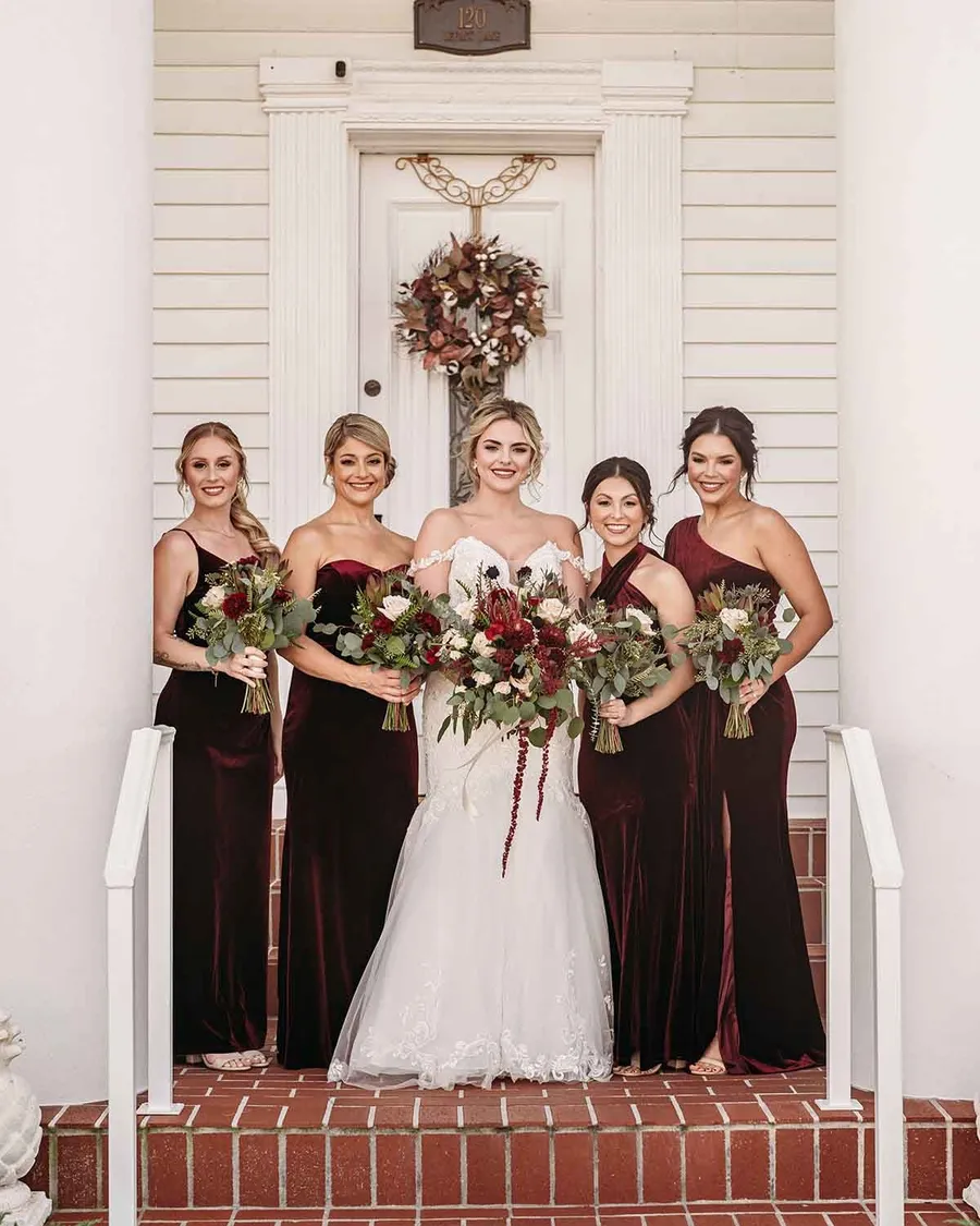 Savanah with her bridesmaids in burgundy on the porch