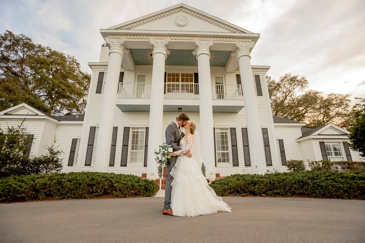 A couple in front of the estate house