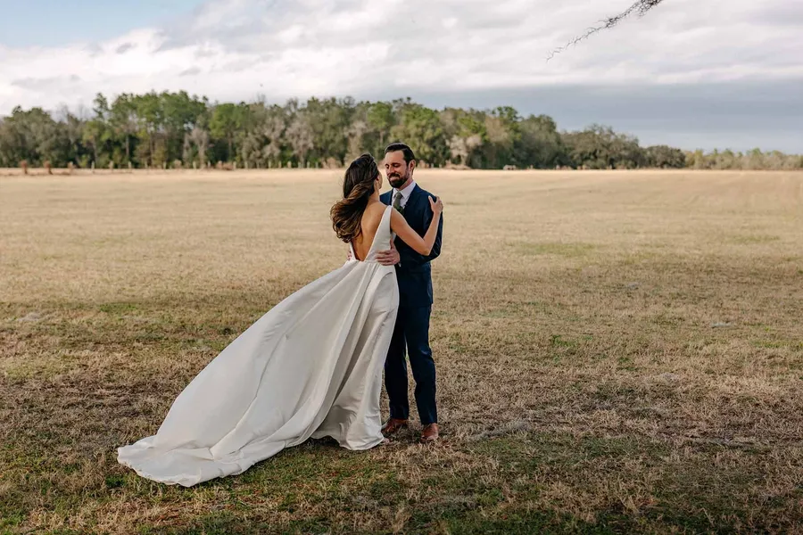 Matt and Marilia hugging in the field