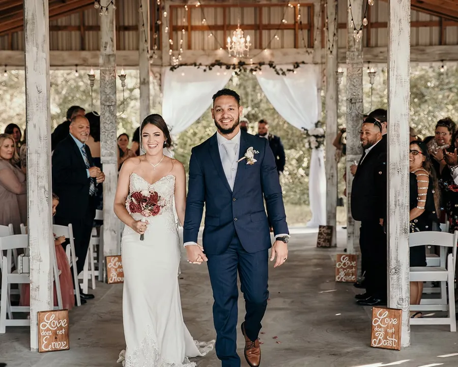 A couple walking up the aisle in the Legacy Pavilion
