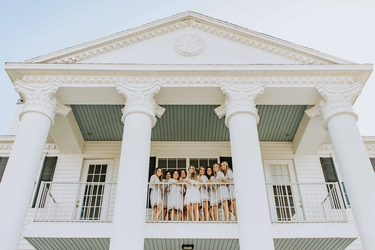 A bridal party on the porch of the Bridal Estate