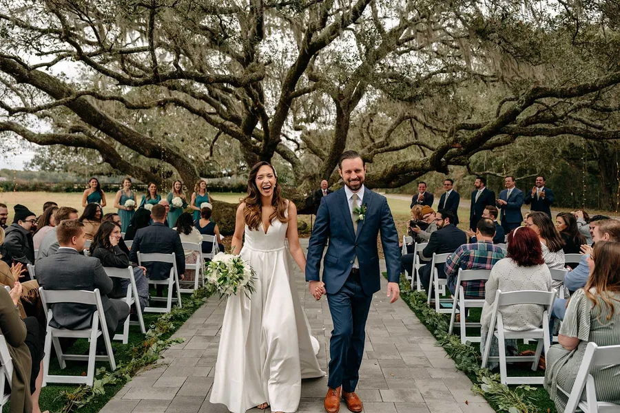 Matt and Marilia walking back up the aisle