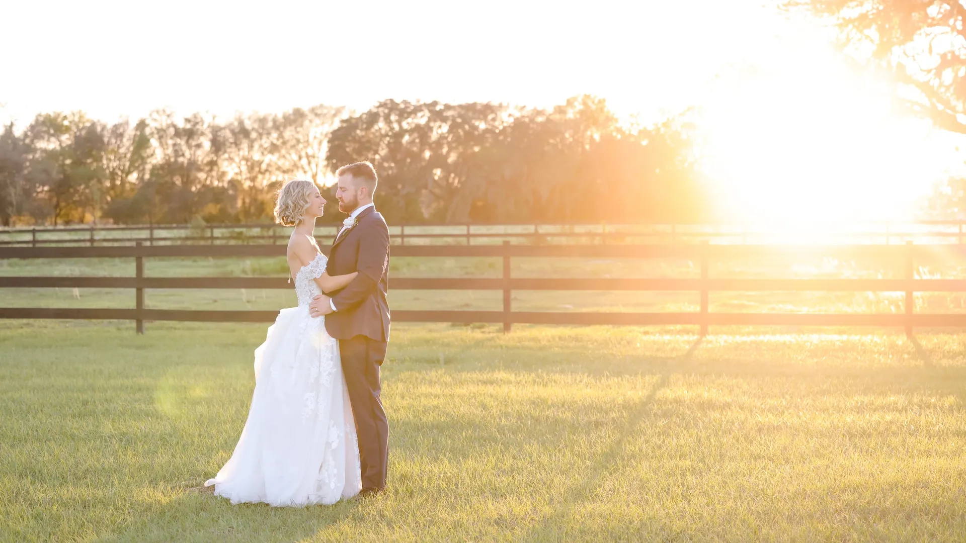 A couple in the field at sunset