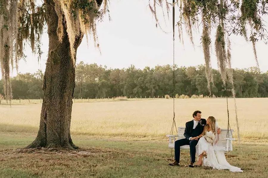 A couple on the swing under the oak